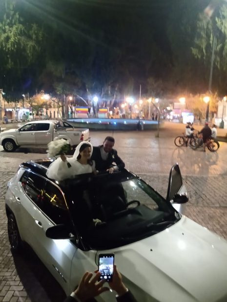 Bride and groom in a white car