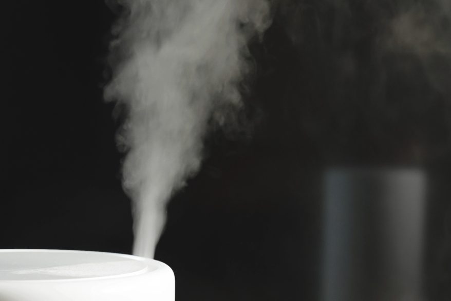 A humidifier humidifies the air with white mist