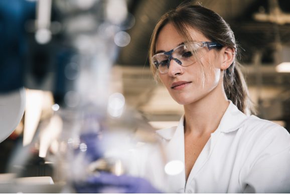 Nikki Burgher in the lab wearing safety glasses.