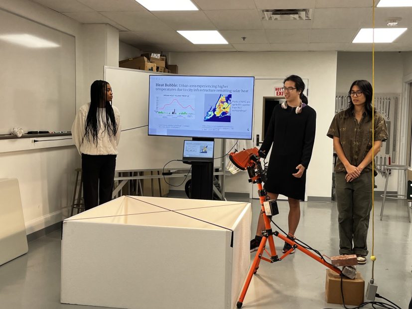 Cordelia Hu, Maeve Chen, and Alison Anderson present their final prototype, a scale model of three New York City neighborhoods.